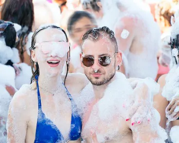 A couple enjoying Foam Machine Rental in Peoria IL while at an outdoor party