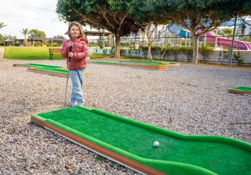 A young girl plays Portable Mini Golf in the Quad Cities