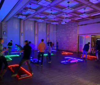 Portable mini golf indoors with LED lights, rented from and set up by Mike's Trackless Trains for Peoria and Bloomington, IL