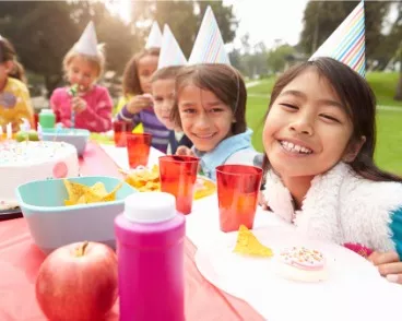 A happy group of children at an outdoor birthday party in Central Illinois, getting ready to enjoy entertainment from Mike's Trackless Trains and their birthday party rentals